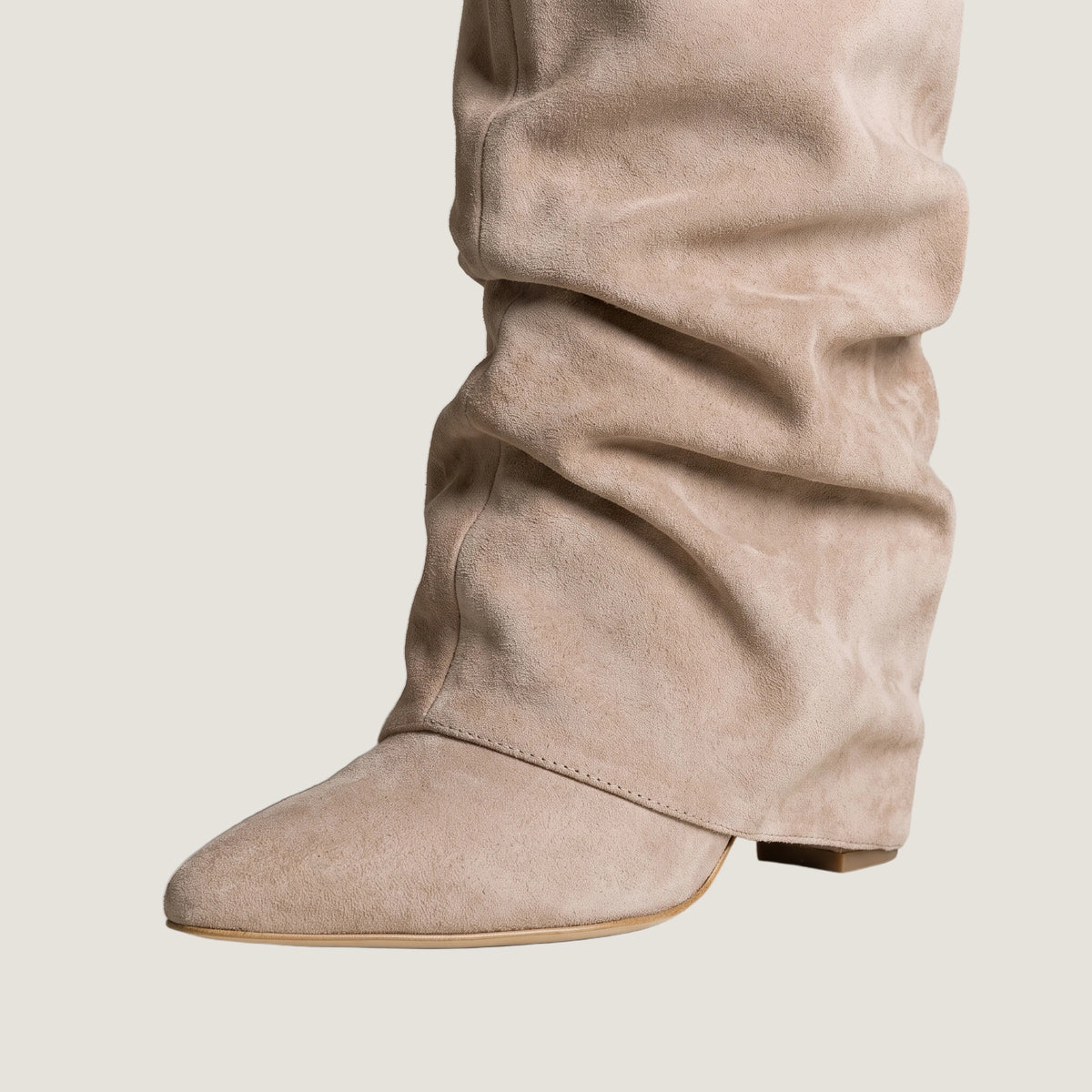 Close-up of the fold-over front panel and concealed wedge heel